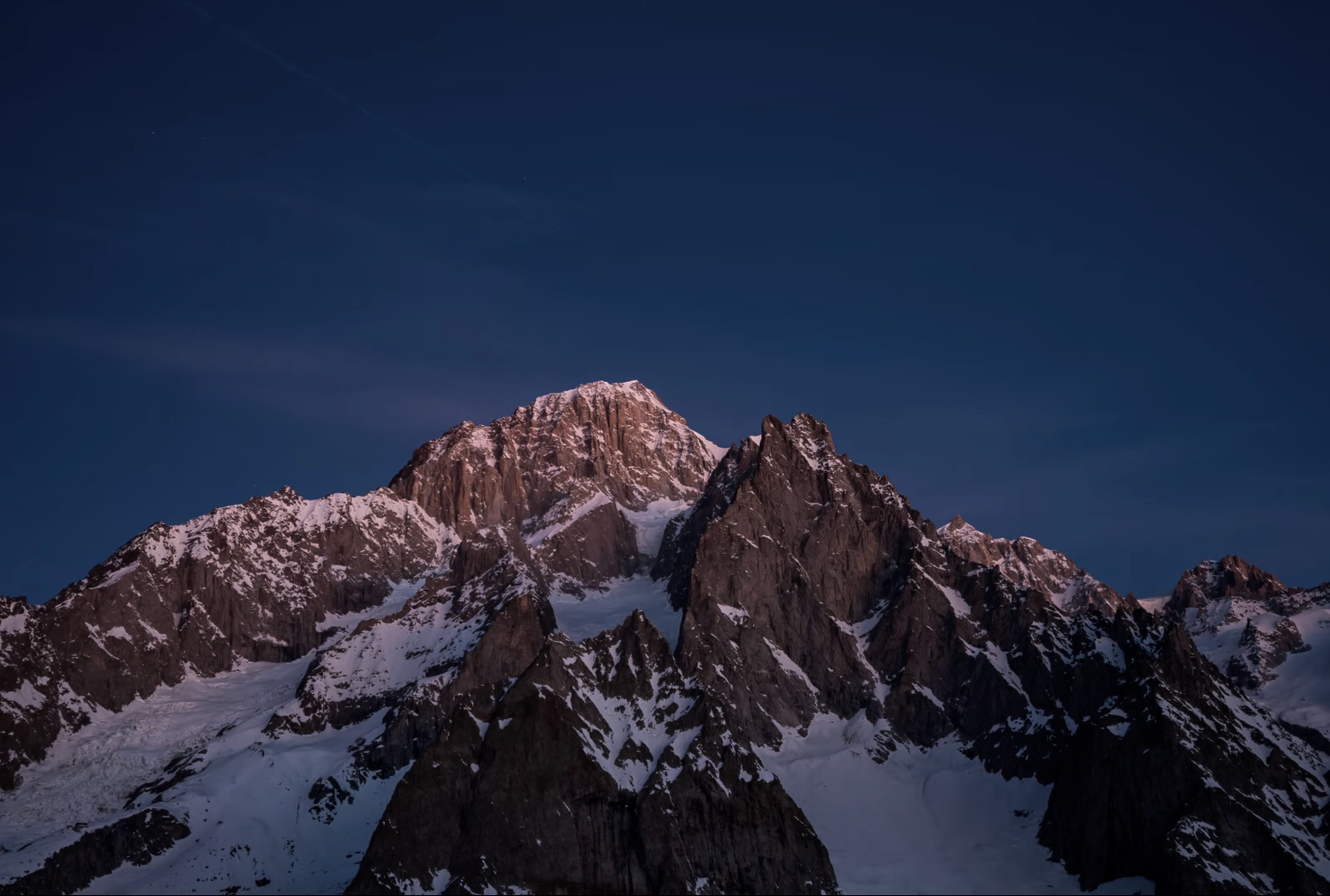 Rock and ice terrain on the Aiguille Noire du Peuterey silhouetted against the sky