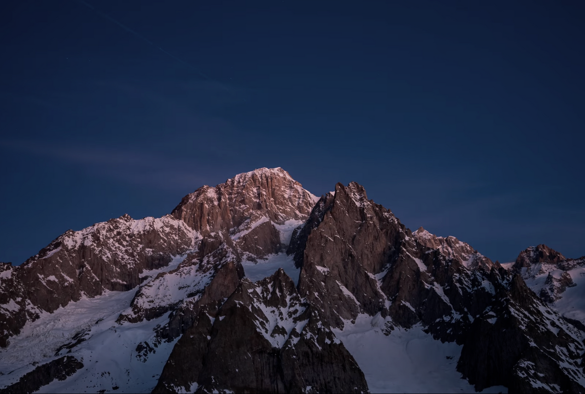 Rock and ice terrain on the Aiguille Noire du Peuterey silhouetted against the sky