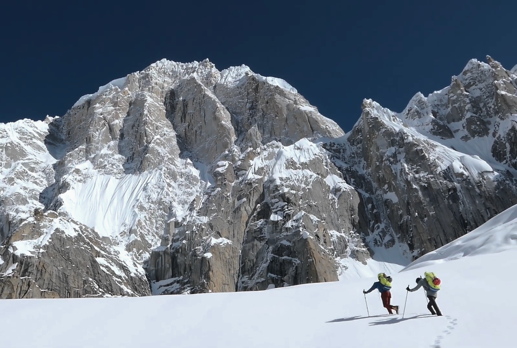 Jérôme Sullivan and Christophe Ogier approaching Pumari Chhish East across snow terrain in the Karakoram