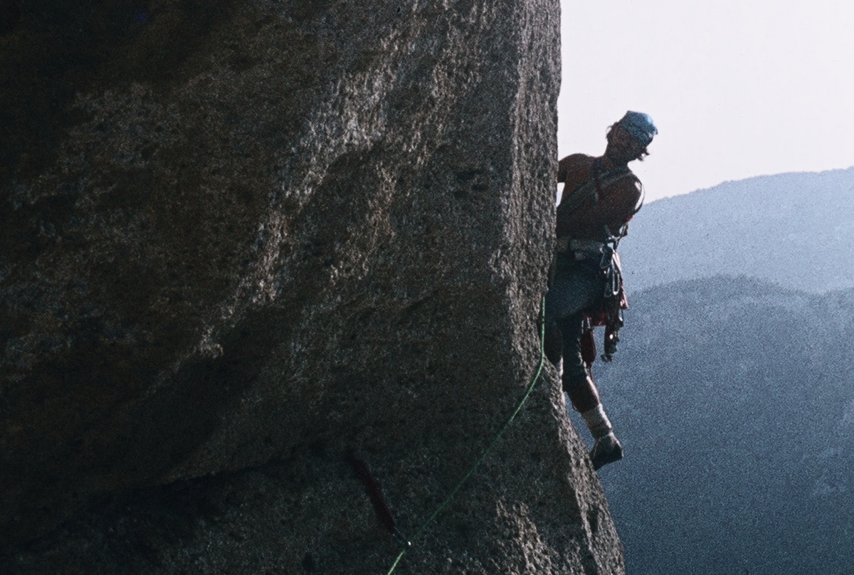 Guido Azzalea climbing a steep rock wall during the early years of sport climbing in Aosta Valley.