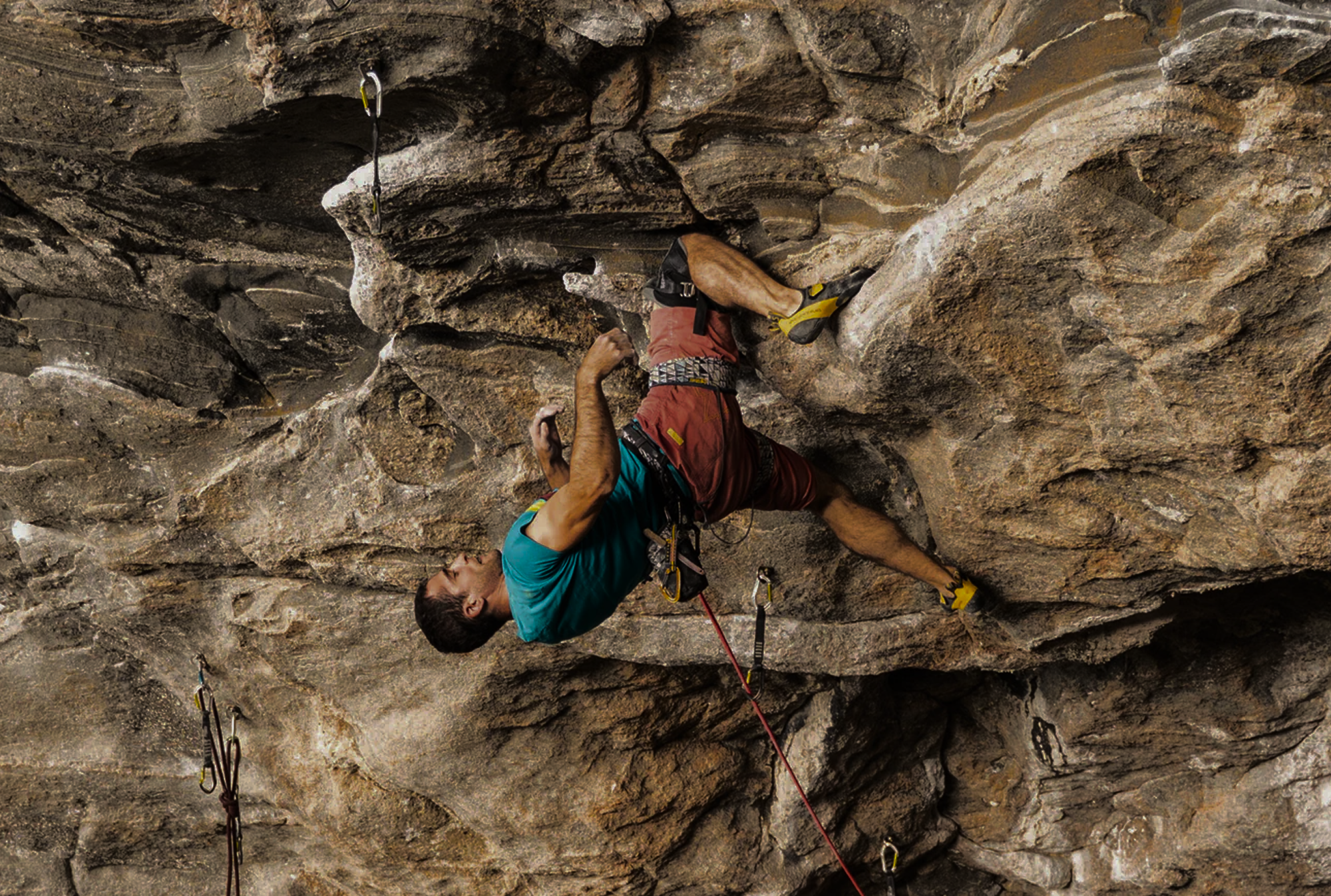 Climber Marcello Bombardi moving through the steep cave routes of Flatanger, Norway.
