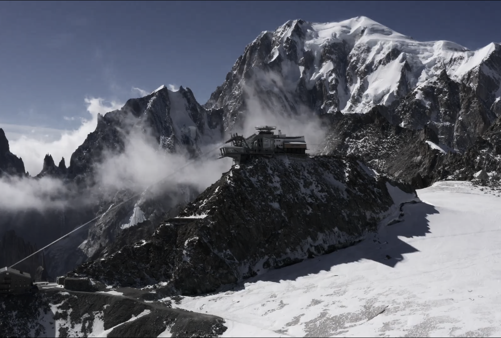 High-angle view of Punta Helbronner and the Skyway Monte Bianco cableway station in the snowy Mont Blanc massif, Italian Alps.