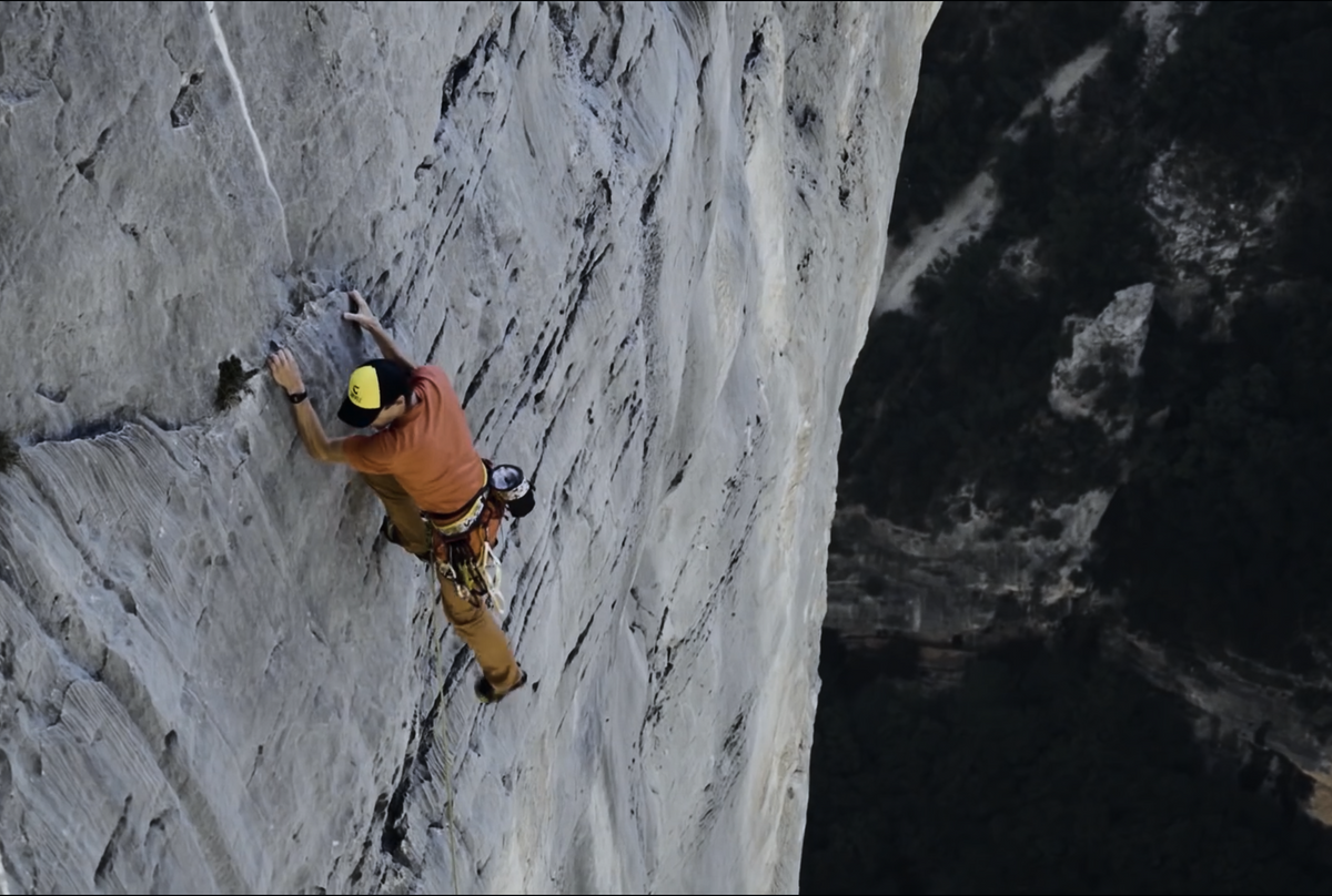 Climber ascending the limestone walls of Verdon Gorge.