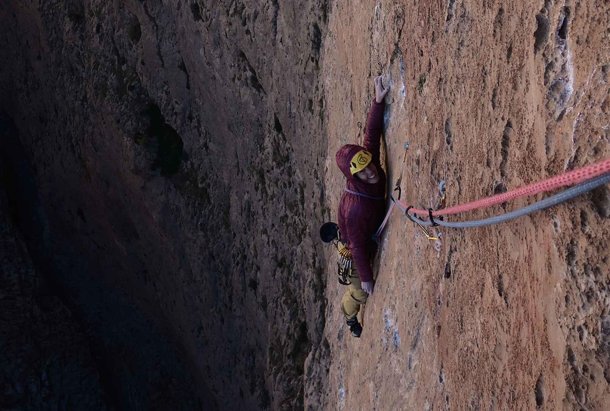 Silvia Loreggian climbing a vertical limestone wall during an expedition in Taghia, Morocco.