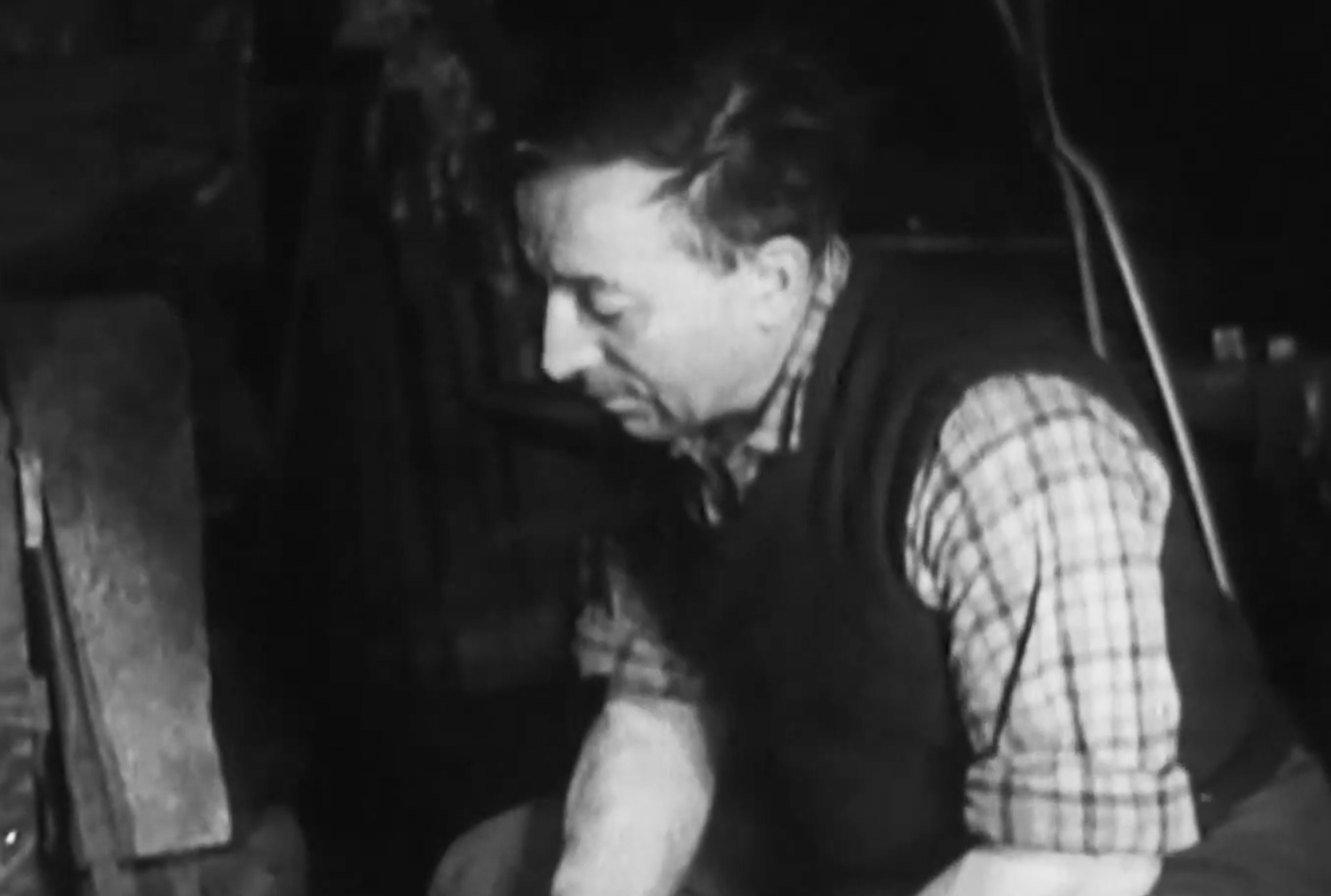 Black and white frame from Mario Fantin’s 1956 documentary showing work inside the Grivel forge.