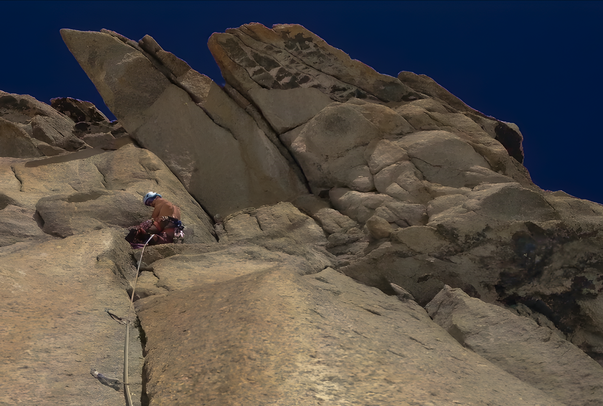 Climber ascending the steep crack system of Greenspit in Valle Orco, Italy.