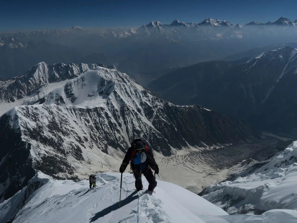 Helias Millerioux ascending a snow ridge above glaciated terrain in the Karakoram.