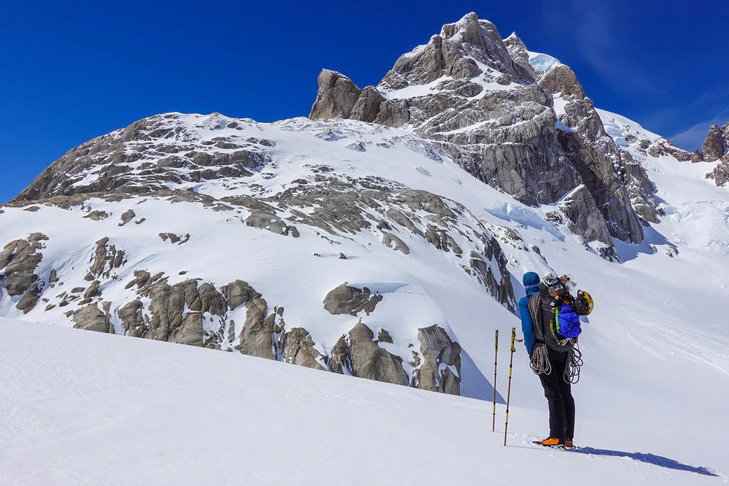 Climber approaching Cerro Nora Oeste across snow terrain