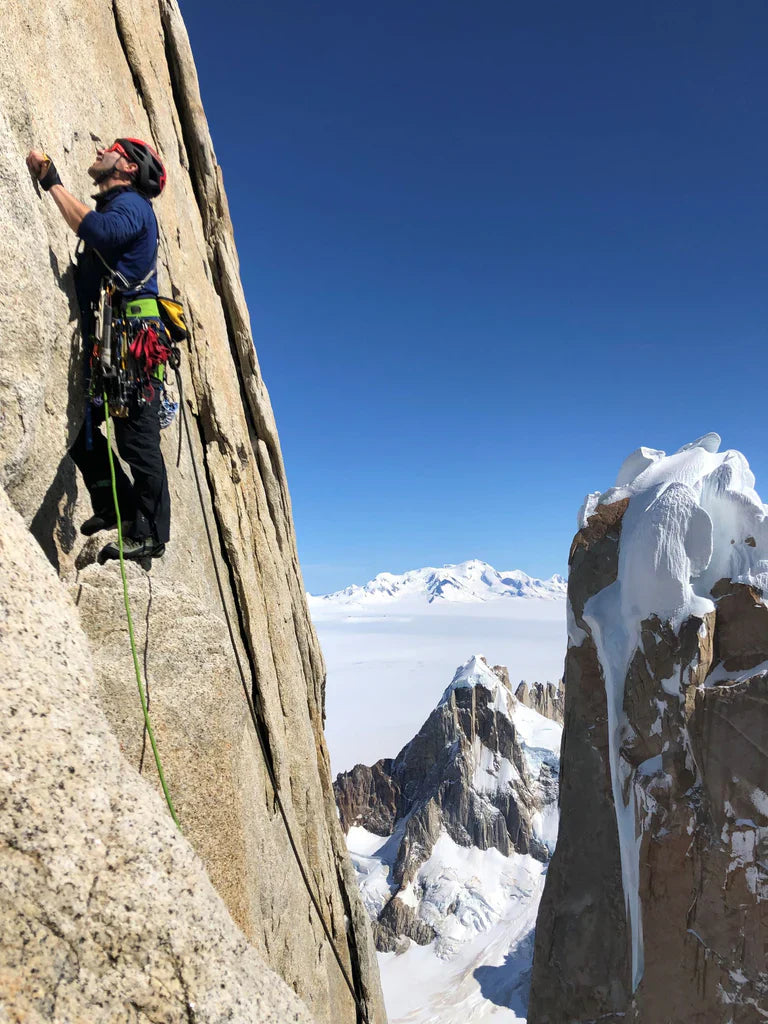 Climber traversing exposed terrain high above the Patagonian icefield