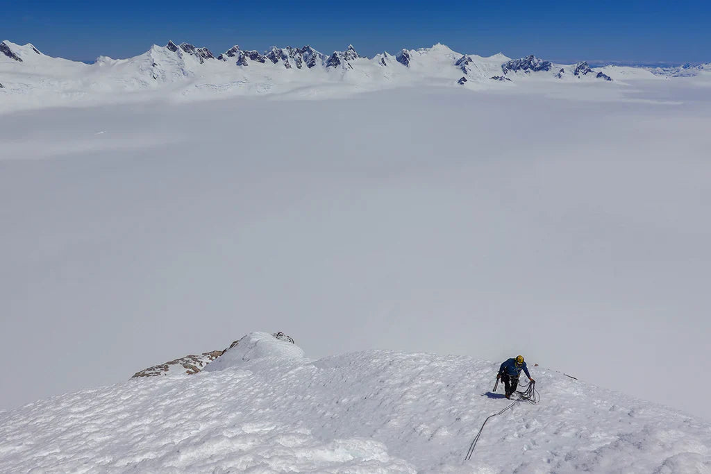 Climber moving across exposed snow terrain in Patagonia