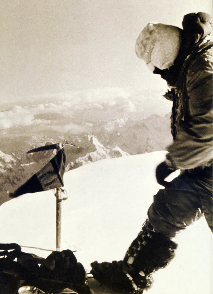 High-altitude mountaineer on a snowy summit during the golden age of Himalayan climbing