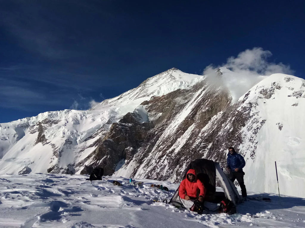 High camp beneath a snow-covered Karakoram peak.
