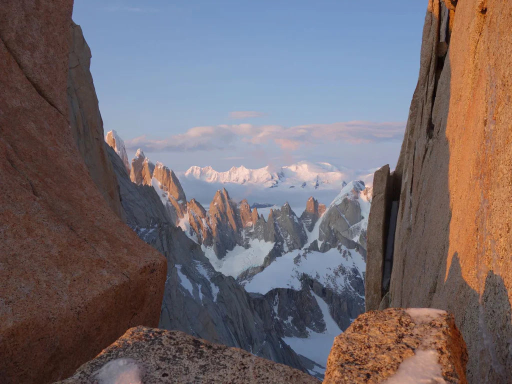 Granite towers and snow-covered peaks seen from a high viewpoint in Patagonia.