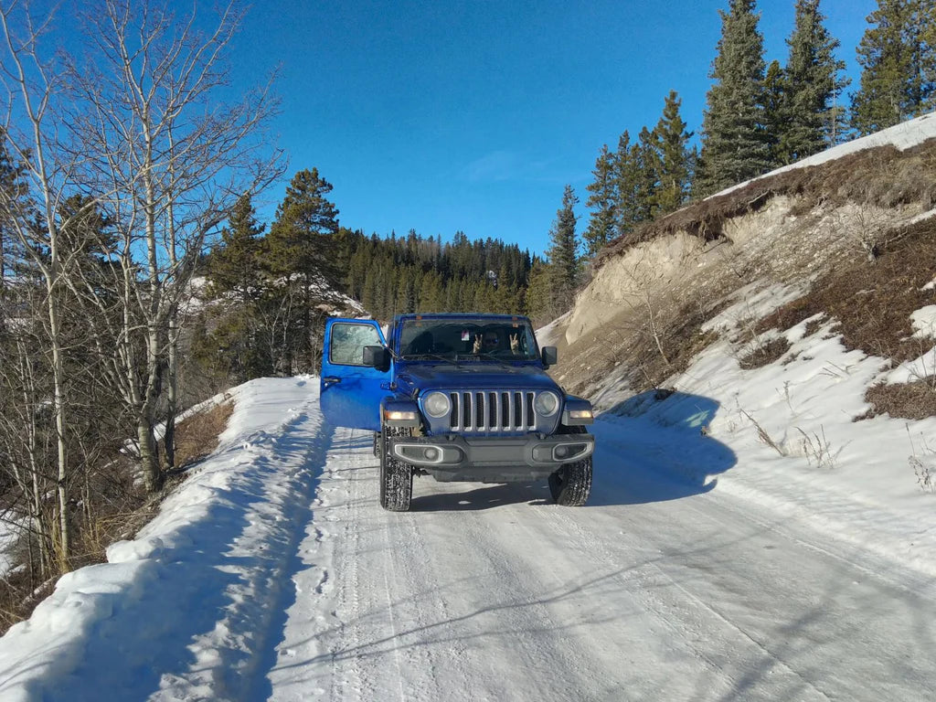 Jeep on a snow-covered road during an ice climbing trip in the Canadian Rockies.