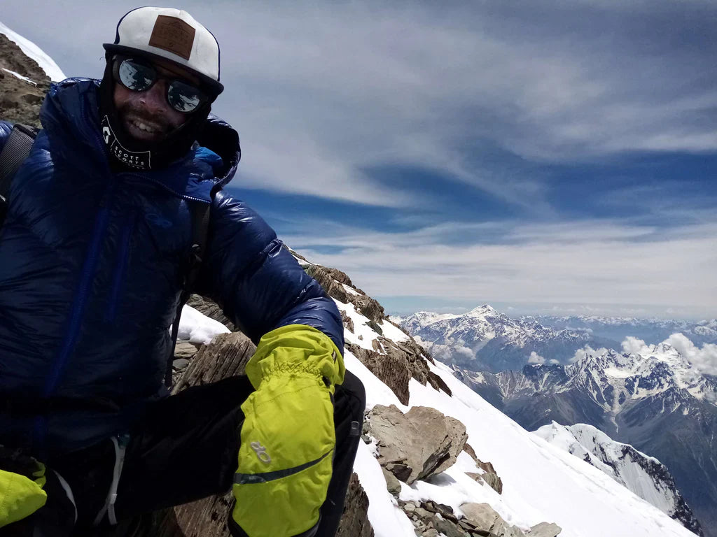 Patrick Wagnon above snow-covered alpine terrain during a Karakoram ascent.