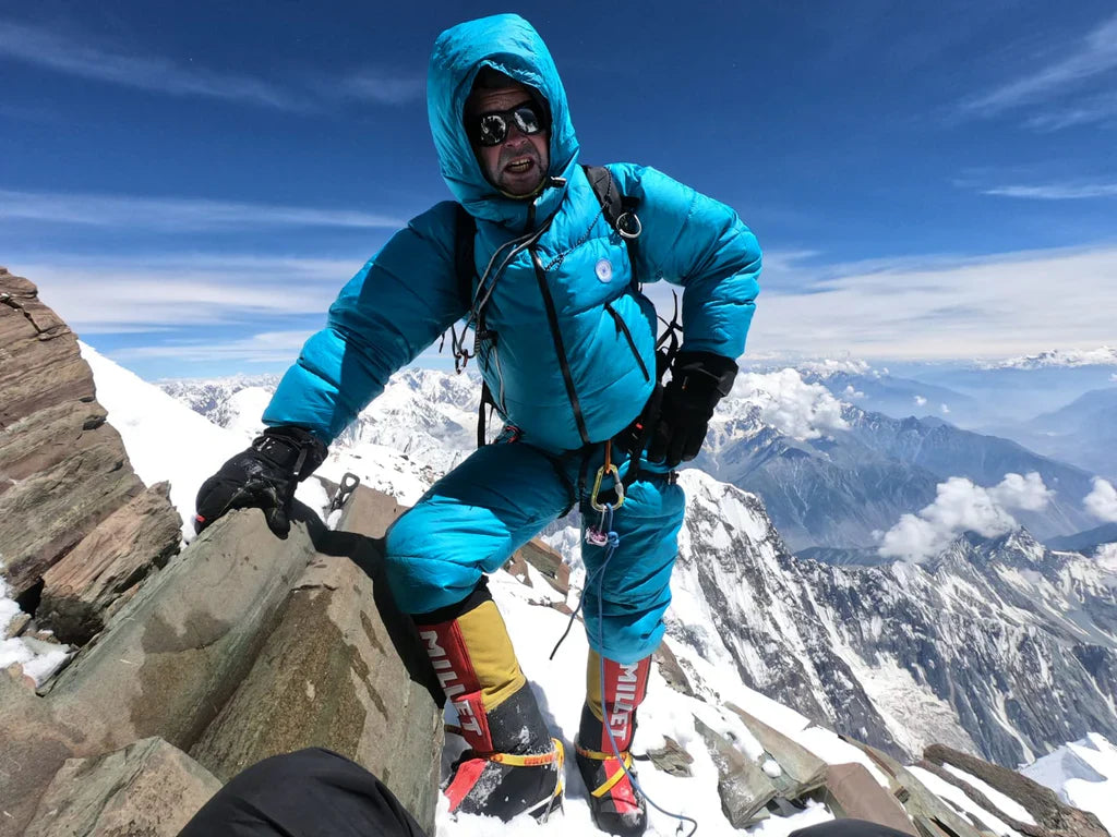 Helias Millerioux on a snow-covered Karakoram summit in high-altitude gear.