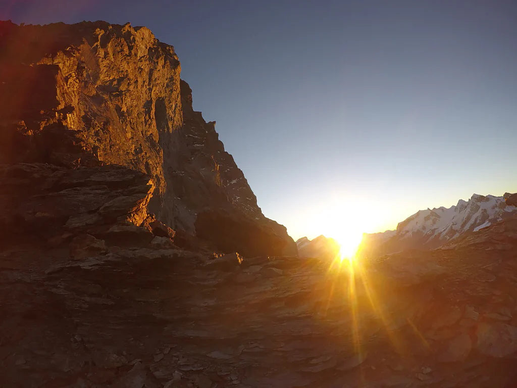 Sunrise beneath the Matterhorn south face during the approach to the Scudo del Cervino route.