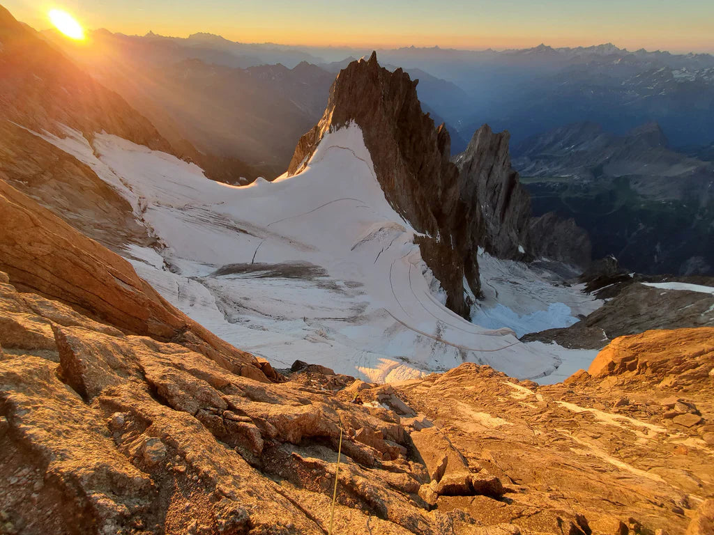 Sunset above alpine terrain during the Intégrale 2.0 traverse in the Mont Blanc massi