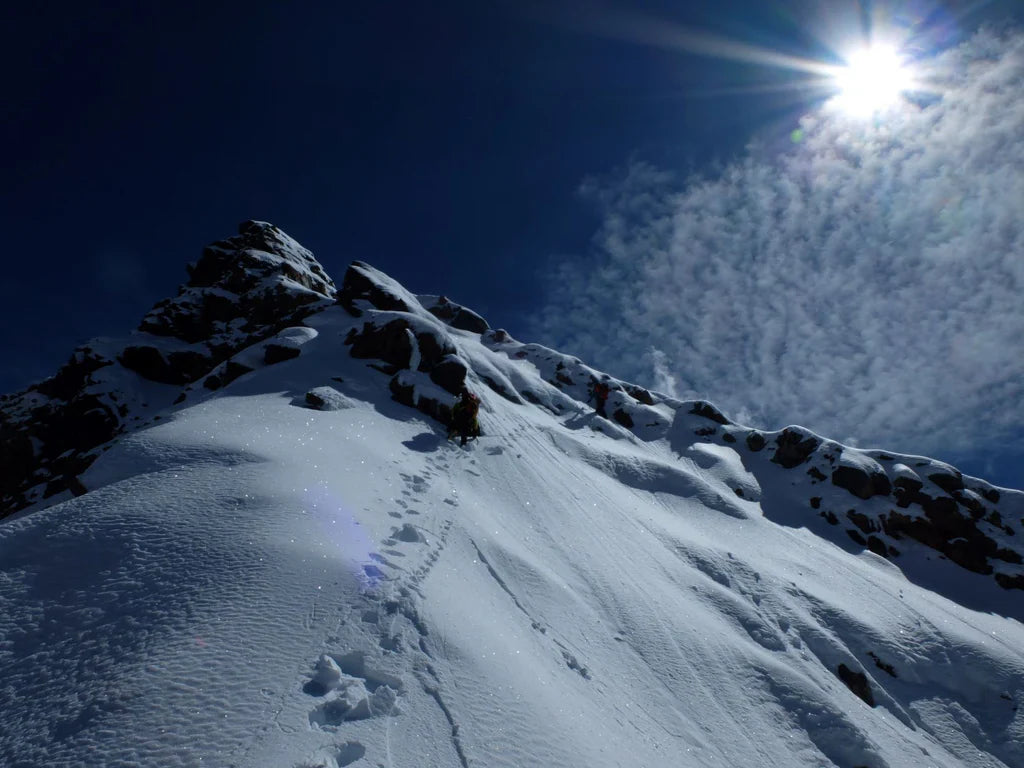 Snow-covered ridge leading toward Pangpoche under a clear Himalayan sky.