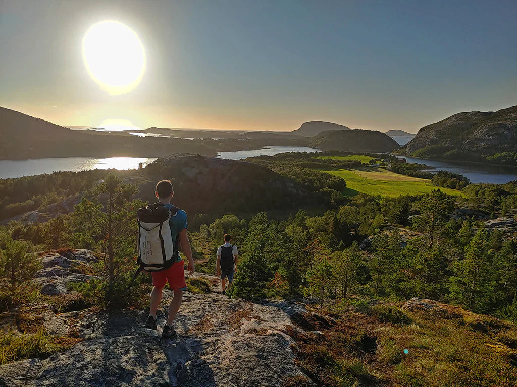 Climbers approaching the Flatanger climbing area through the Norwegian landscape.