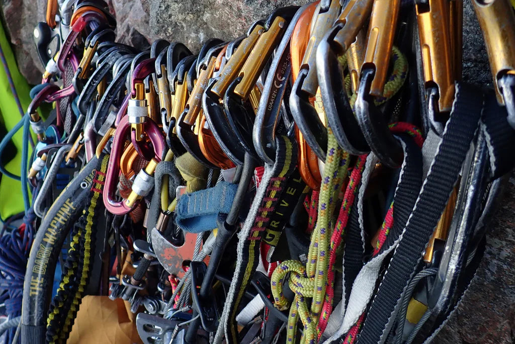 Climbing equipment and carabiners prepared for a wall ascent in the Arctic
