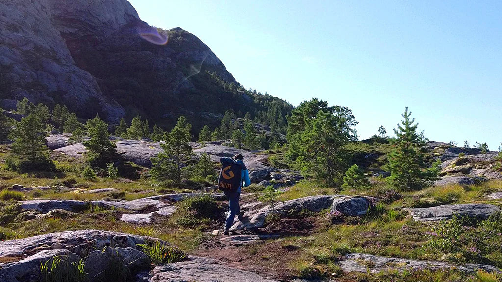 Climbers approaching the Flatanger climbing area through the Norwegian landscape.