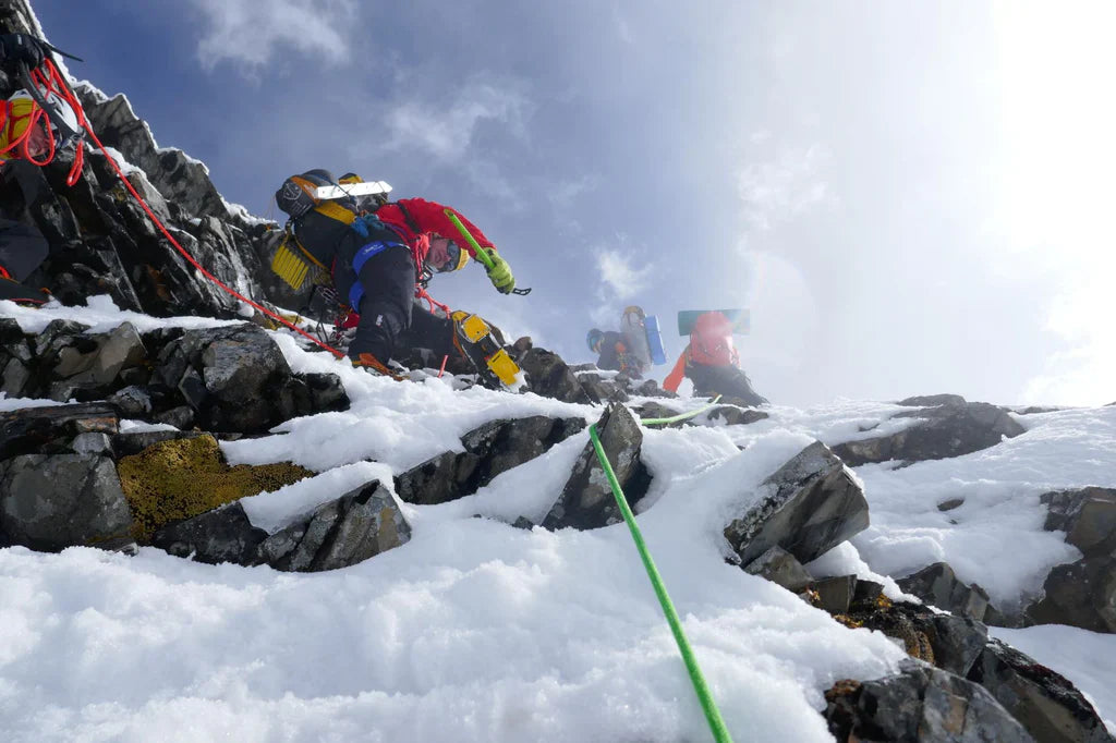 Mountaineers climbing mixed snow and rock terrain during the Pangpoche attempt.