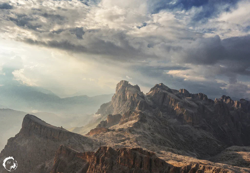 Mountain landscape beneath dramatic storm light in a remote wilderness environment.