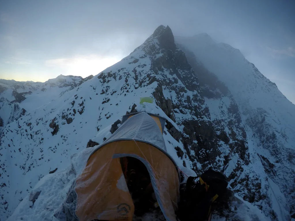 Bivouac tent on a narrow snowy ridge during the attempt to Pangpoche.