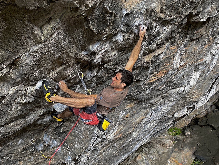 Marcello Bombardi climbing steep cave terrain in Flatanger.
