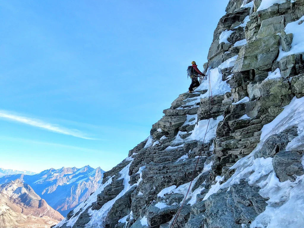 Climber traversing mixed terrain on the Bonatti Route, Matterhorn north face