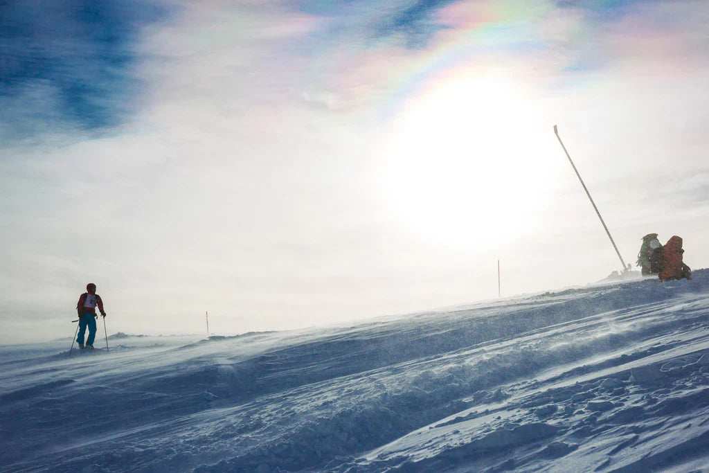 Windblown snow across an alpine ski slope