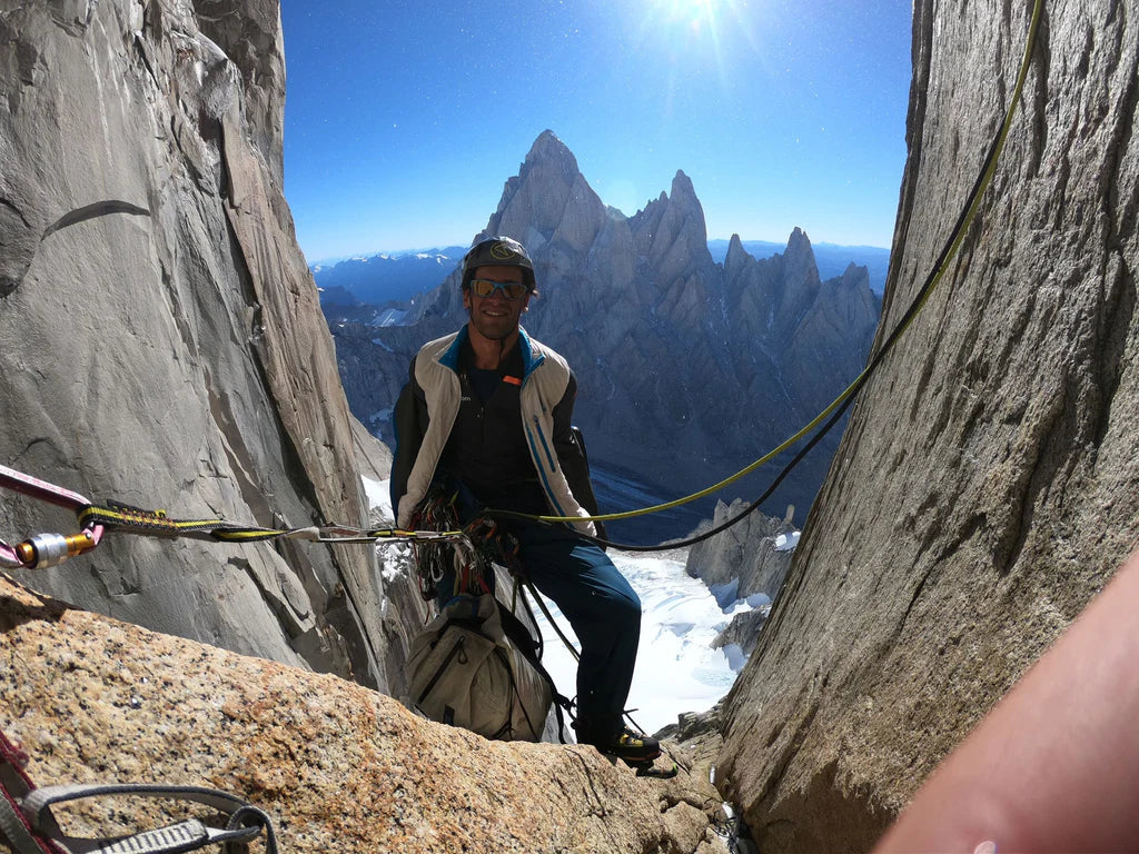 Tomás Aguiló at a belay high on Cerro Torre with the Fitz Roy massif in the background