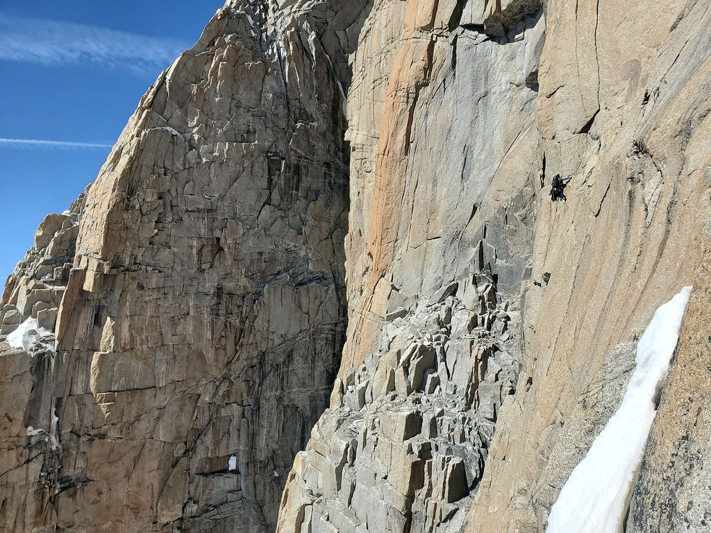Damien Tomasi climbing steep granite terrain in the Mont Blanc massif