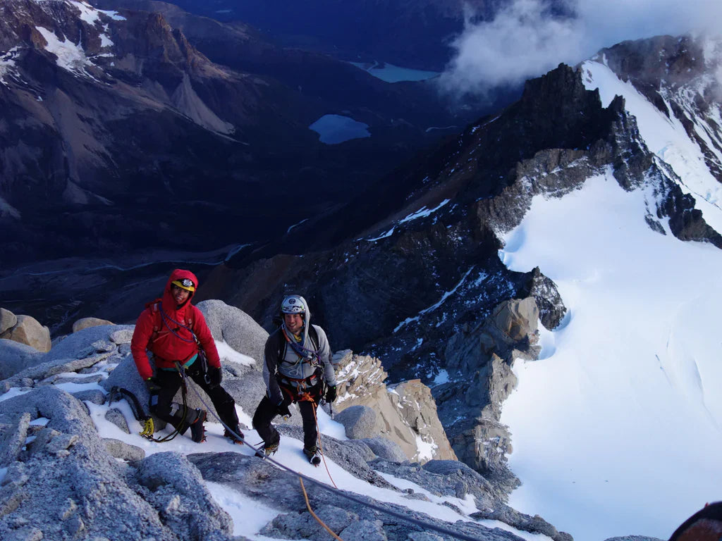 Silvia Loreggian and Stefano Ragazzo on a snowy ridge high above Patagonian valleys.