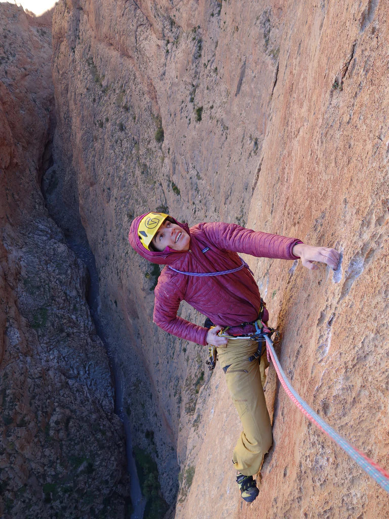 Silvia Loreggian climbing a vertical limestone route in Taghia, Morocco.