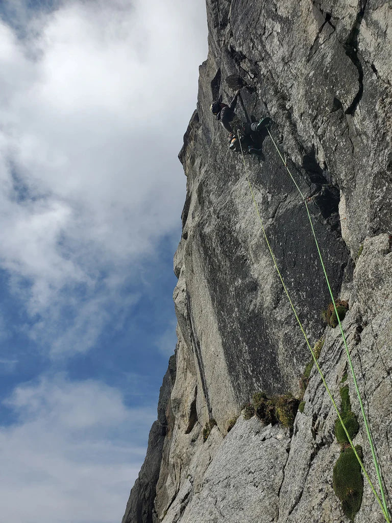 Damien Tomasi climbing steep granite terrain in the Mont Blanc massif