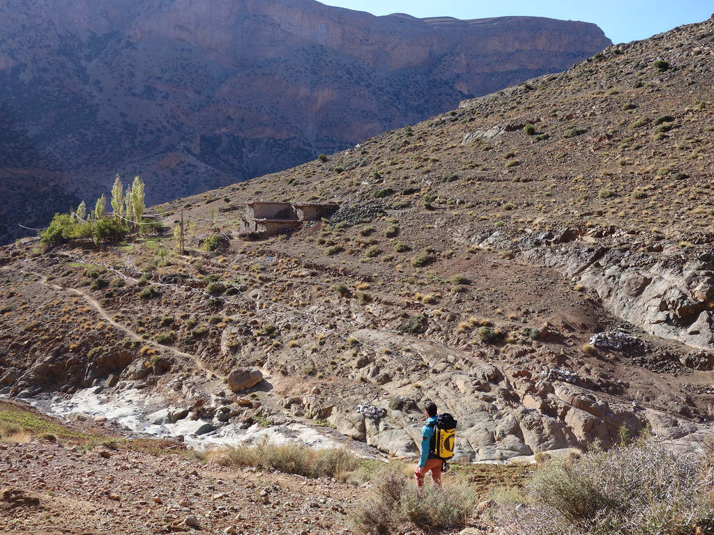 Stefano Regazzo descending a rocky trail during the Taghia climbing expedition.
