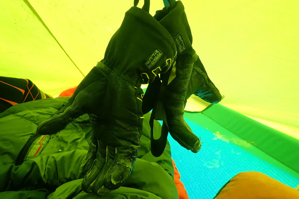 Frozen climbing gloves drying inside the expedition tent