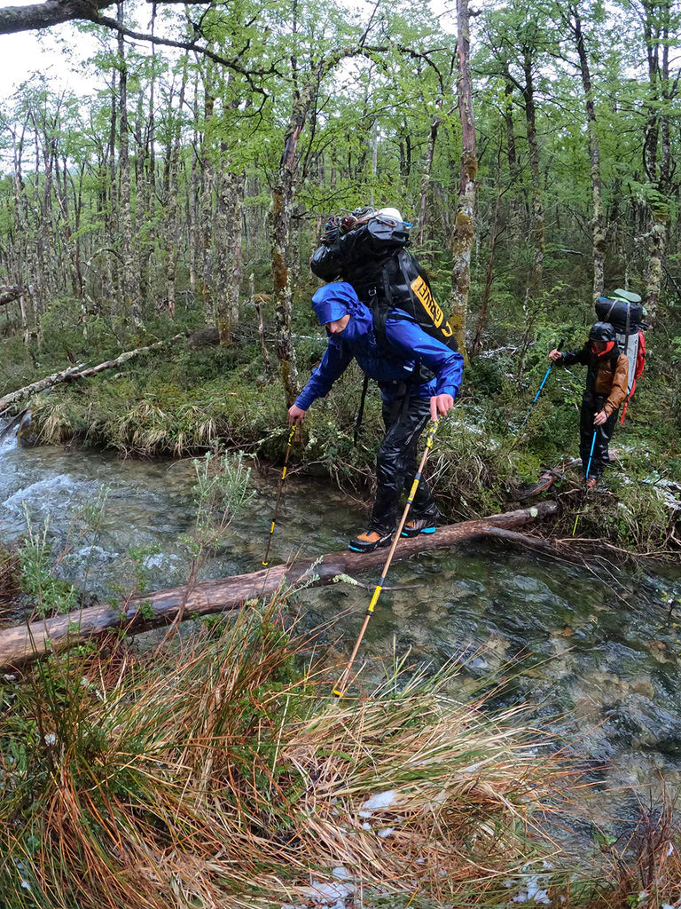 Luca Schiera crossing forest terrain during the Patagonia approach