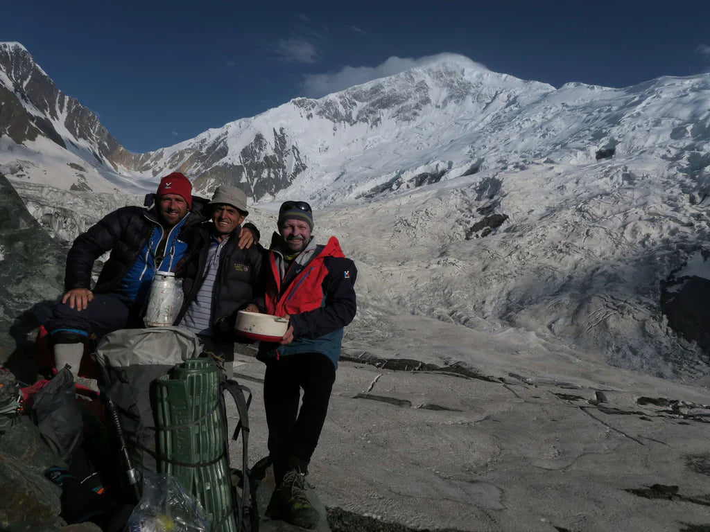 Yannick Graziani and expedition partners beside glacial terrain in the Karakoram.